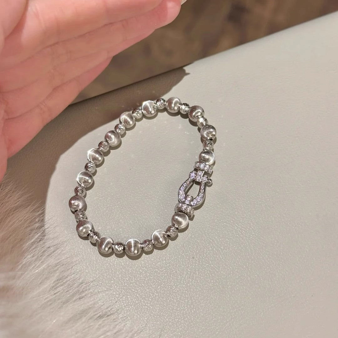 Silver-tone bracelet showing alternating bead textures