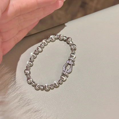 Silver-tone bracelet showing alternating bead textures