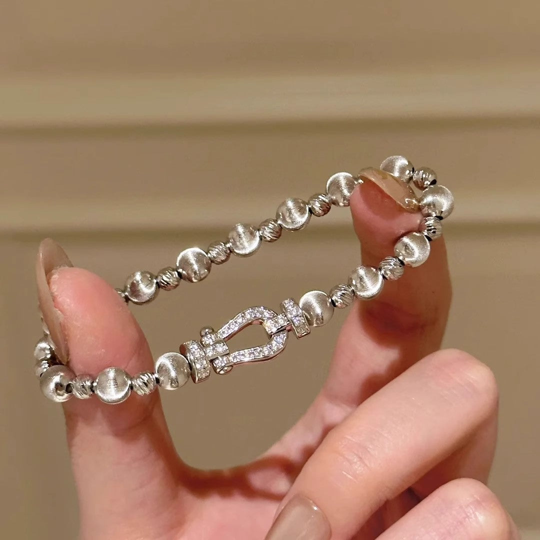 Silver-tone bracelet with rhinestone horseshoe centerpiece