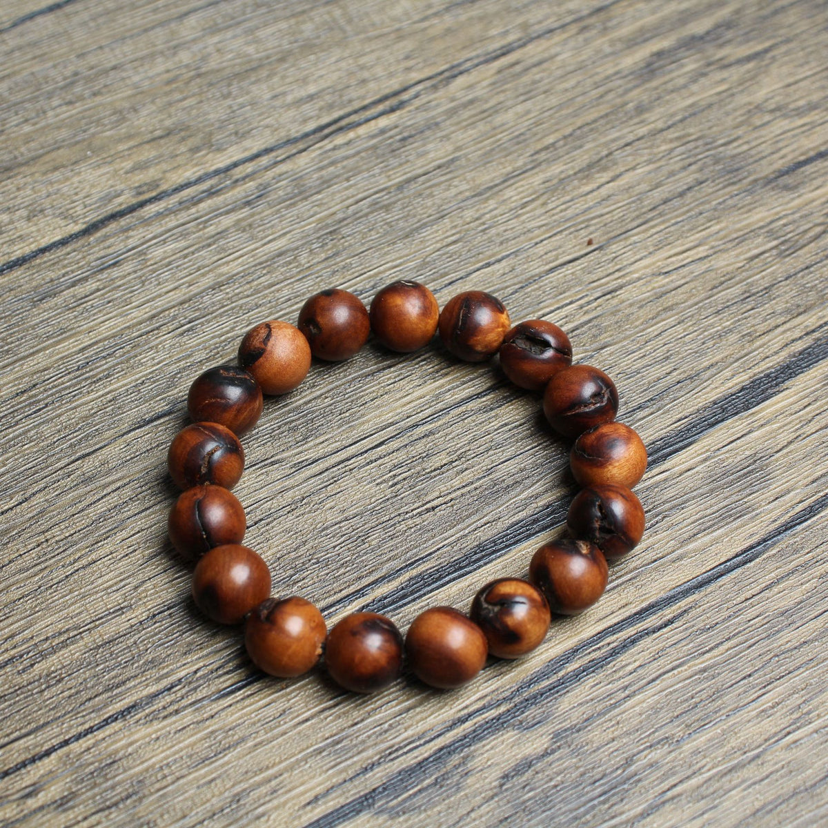 17-bead jujube wood bracelet on a wooden surface