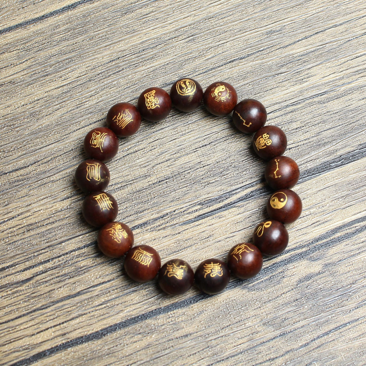 Gold-tone traditional carvings and reddish-brown jujube wood bead detail