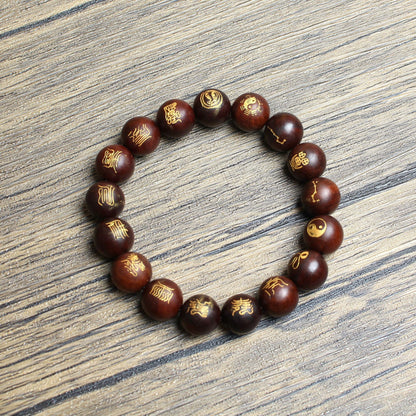 Gold-tone traditional carvings and reddish-brown jujube wood bead detail