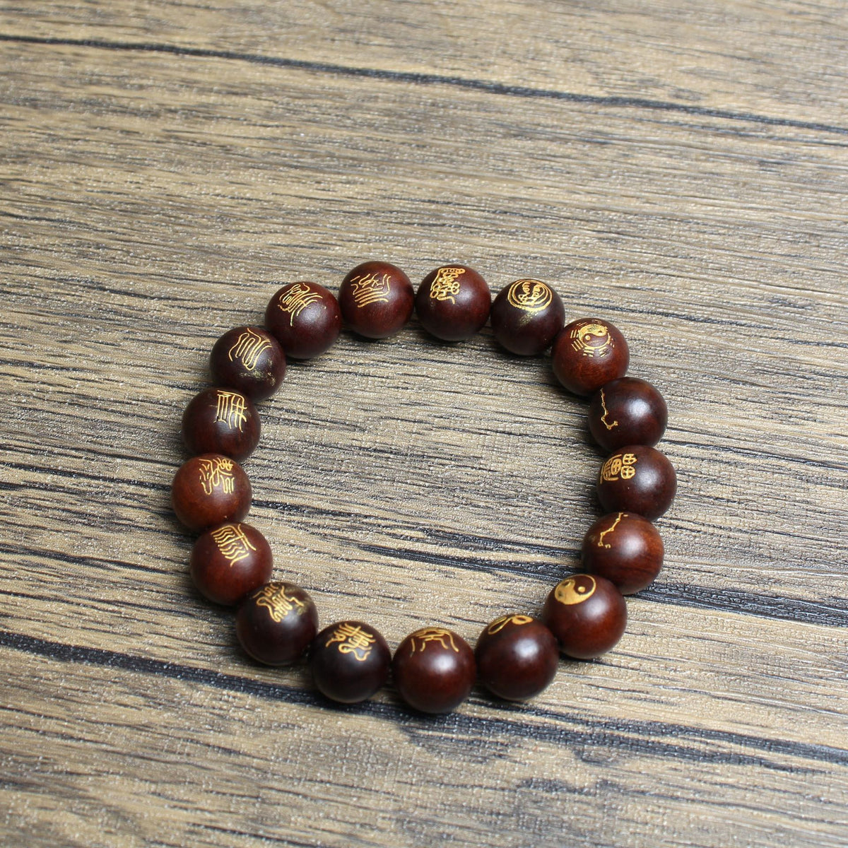 Single-loop seventeen-bead jujube wood bracelet on a wooden surface