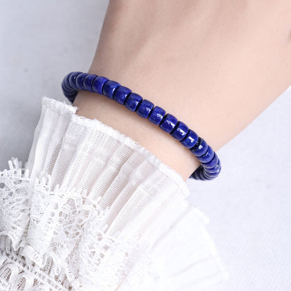 Lapis lazuli bead bracelet worn on a wrist