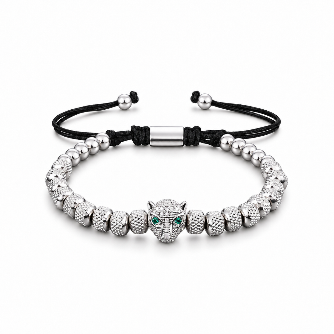 Green-eyed leopard head bracelet on a white background