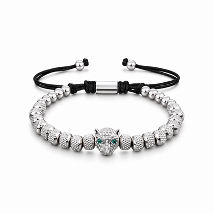 Green-eyed leopard head bracelet on a white background