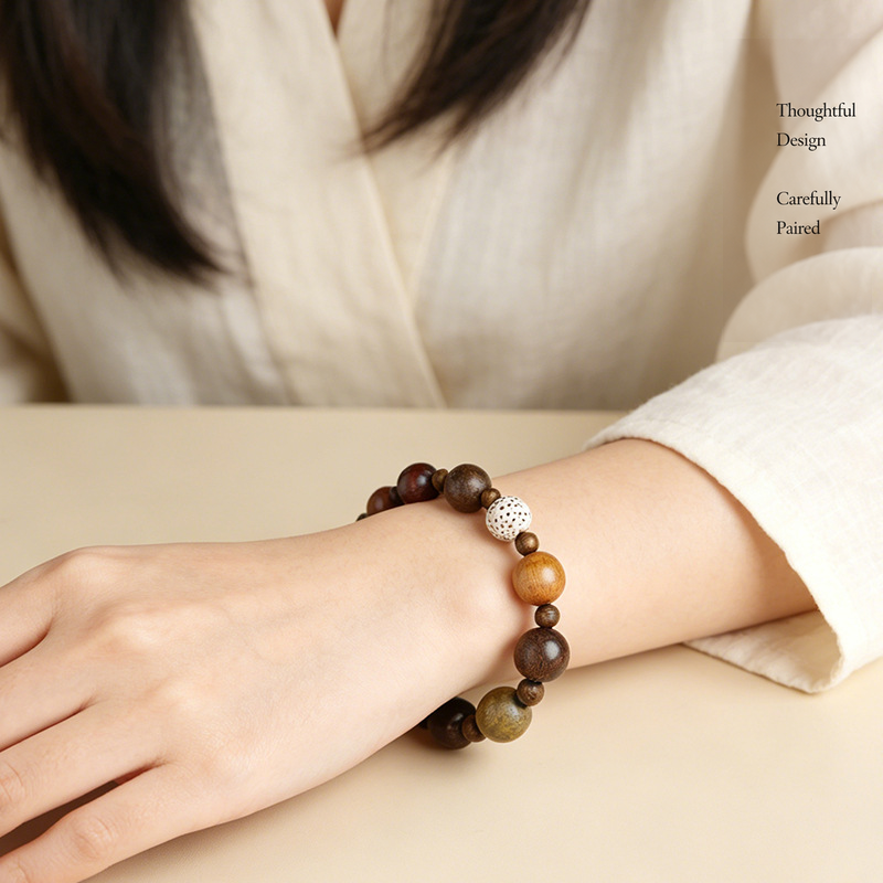 Mixed wood bead bracelet worn on a wrist