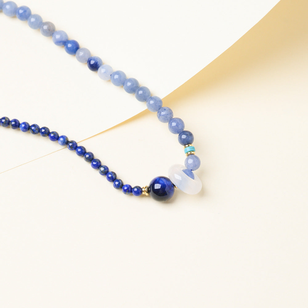 Close-up of blue tiger’s eye accent and chalcedony ring