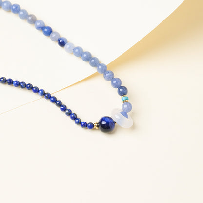 Close-up of blue tiger’s eye accent and chalcedony ring
