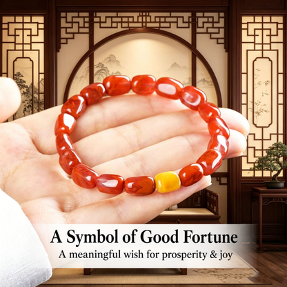 Red agate and amber bracelet held in a hand