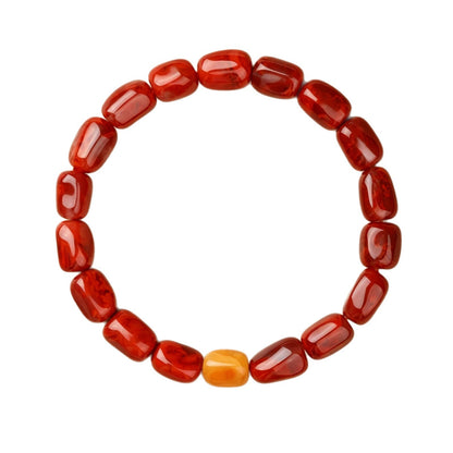 Red agate and amber bracelet photographed from above on white