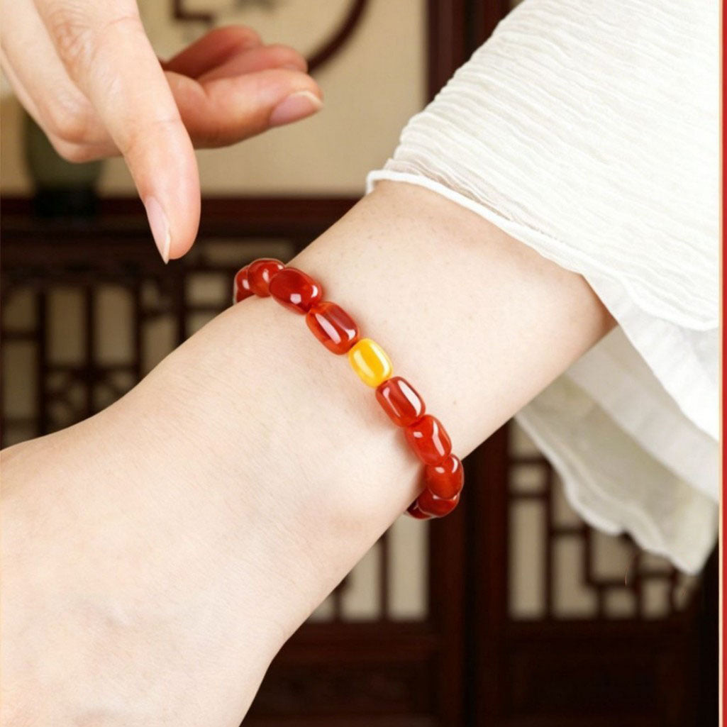 Red agate and amber bracelet worn on a wrist