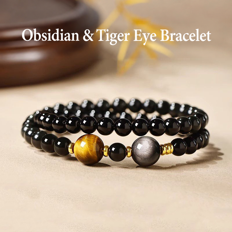 Obsidian and tiger eye double-wrap bracelet on a beige tabletop