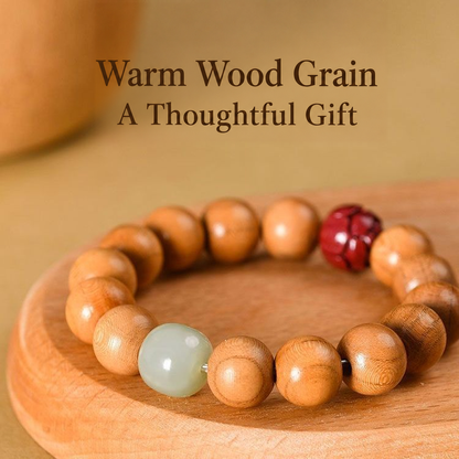 Peach wood lotus bracelet on a wooden tray showing accent beads