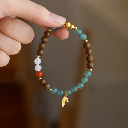 Close-up of the bracelet and gold-tone gourd bead