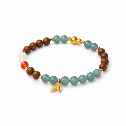 Pear incense and blue chalcedony bracelet with gold-tone gourd and leaf details on white