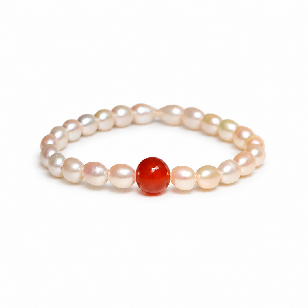 Freshwater pearl and red agate bracelet on a white background