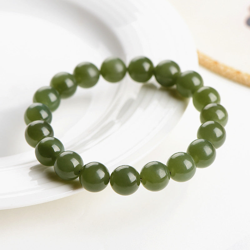 Deep green jade bracelet shown at an angled view
