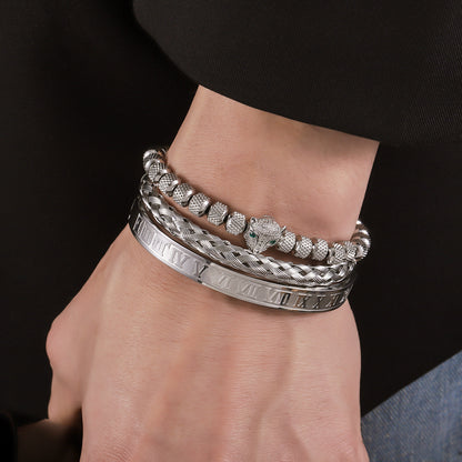 Wrist close-up of leopard head, braided cuff and Roman numeral bangle; sold individually