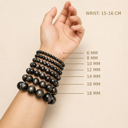 Silver Sheen Obsidian – bead size comparison on a 15–16 cm wrist