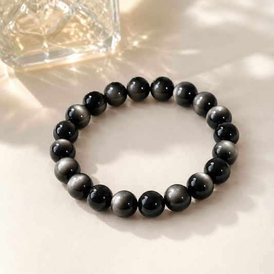 7A Silver Sheen Obsidian Bracelet – Multi-Size – diagonal glass-bottle still life