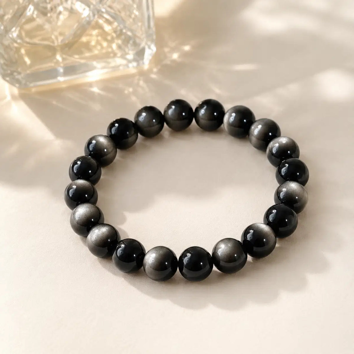 7A Silver Sheen Obsidian Bracelet – Multi-Size – diagonal glass-bottle still life