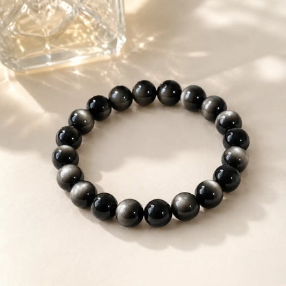 7A Silver Sheen Obsidian Bracelet – Multi-Size – diagonal glass-bottle still life