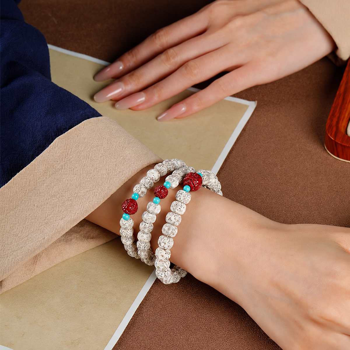 Three star and moon bodhi bracelets styled together on a wrist; each purchase includes one bracelet