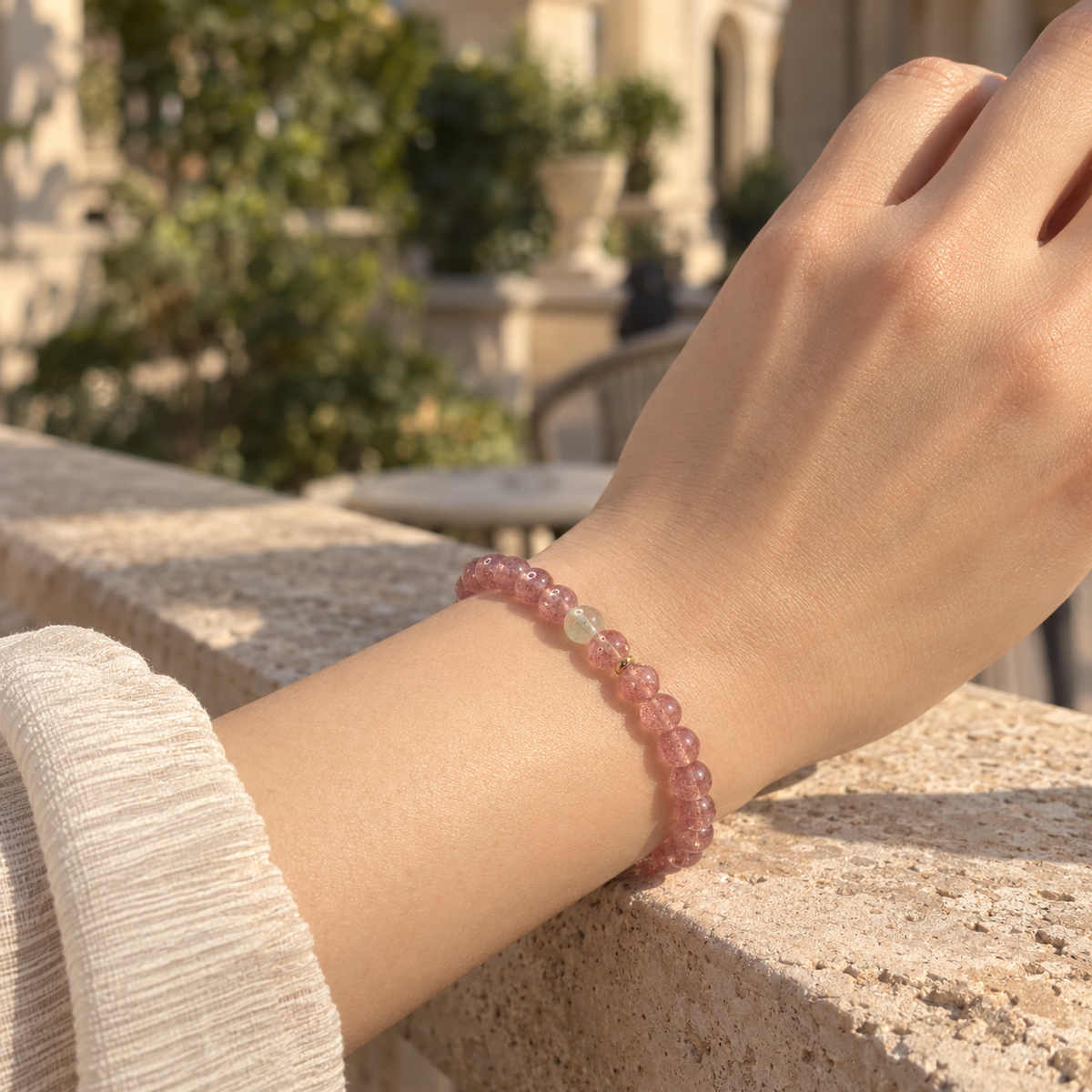 Strawberry Quartz & Citrine Bracelet – 6mm worn outdoors by a stone ledge