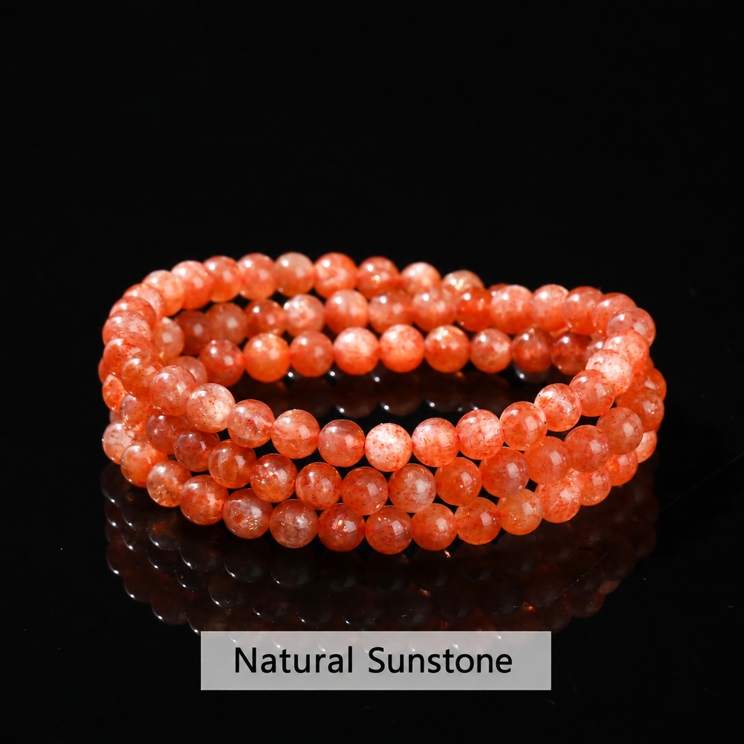Orange sunstone bracelet on black showing natural sparkle