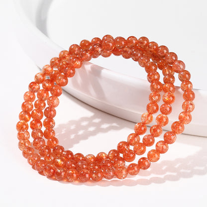Sunstone triple-wrap bracelet displayed on white ceramic