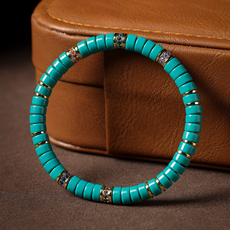 Complete tablet bead bracelet showing gold-tone rings and six accent bands