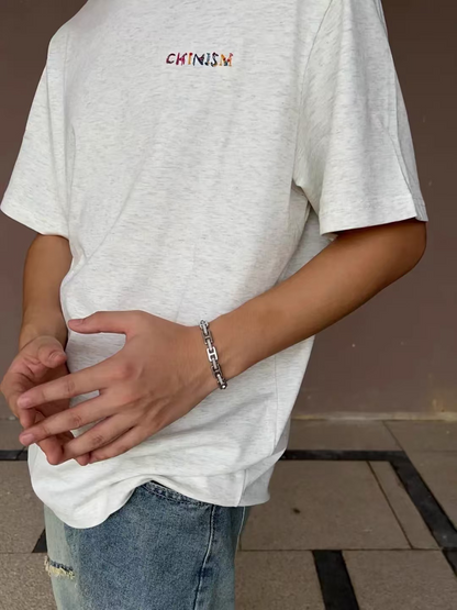 Silver-tone H-link bracelet worn on the wrist