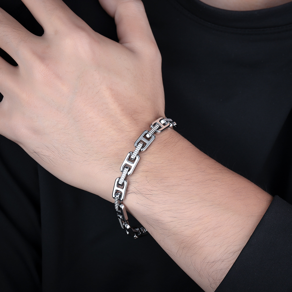 Close-up wrist view of the silver-tone H-link bracelet
