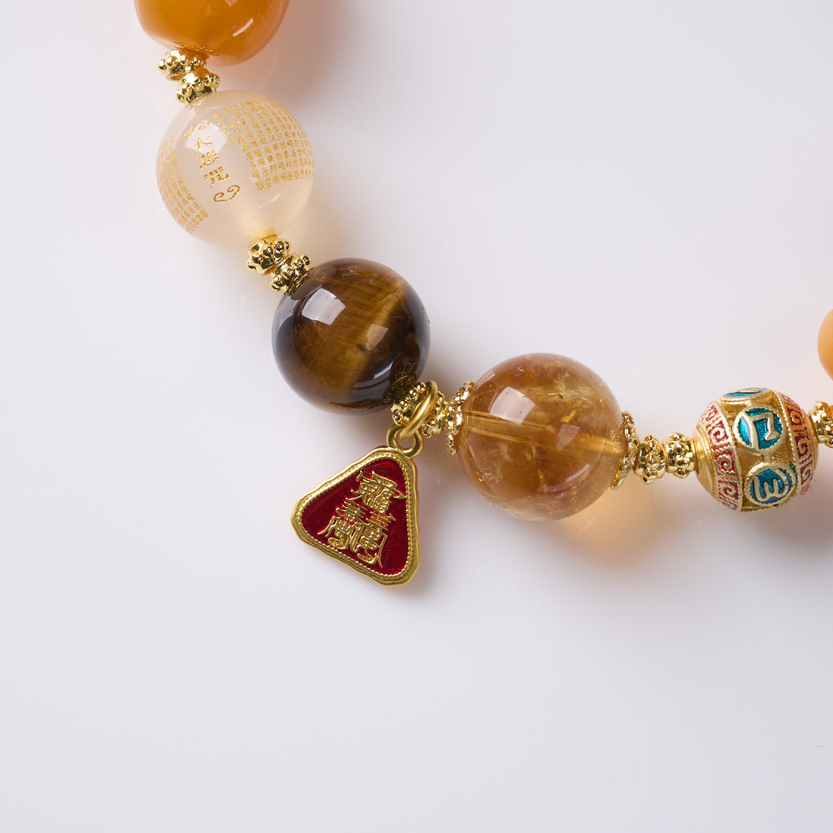 Golden Abundance bracelet close-up of beads and symbolic charm