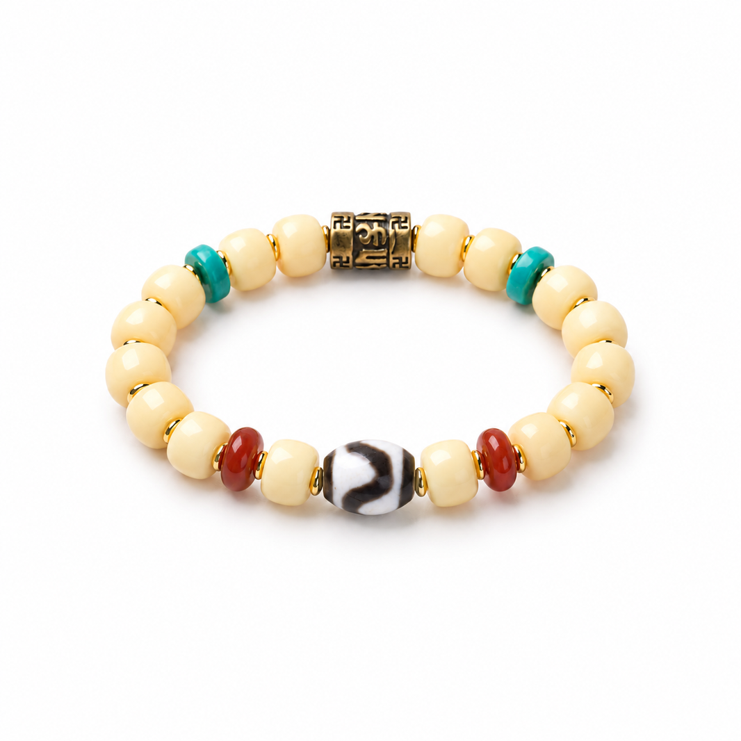 Cream Bodhi barrel bead bracelet with brass mantra bead and patterned Dzi accent
