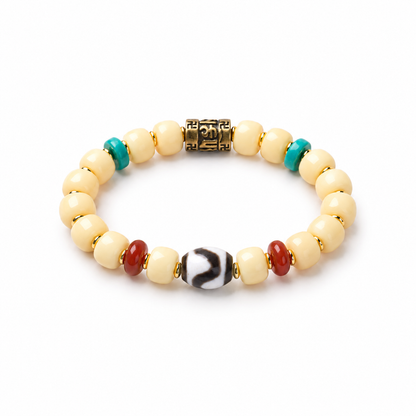 Cream Bodhi barrel bead bracelet with brass mantra bead and patterned Dzi accent