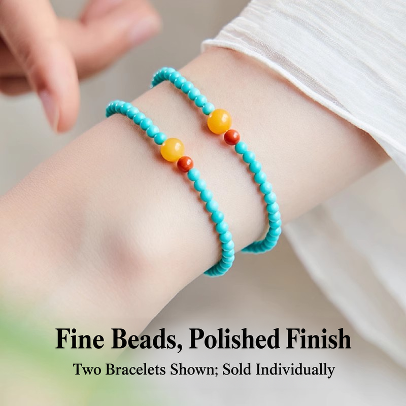 Two turquoise and amber bracelets styled together; sold individually