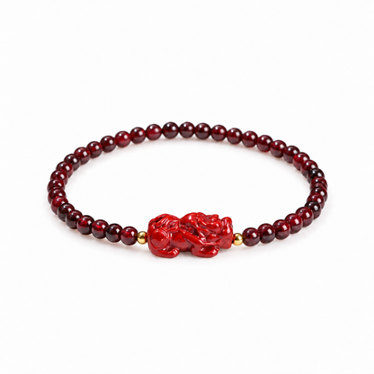 Garnet bracelet with red carved Pixiu and gold-tone beads