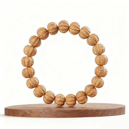 Walnut bead bracelet displayed on a wooden stand