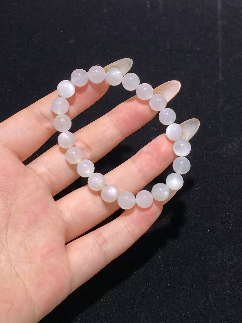 White moonstone bead bracelet – size shown against hand