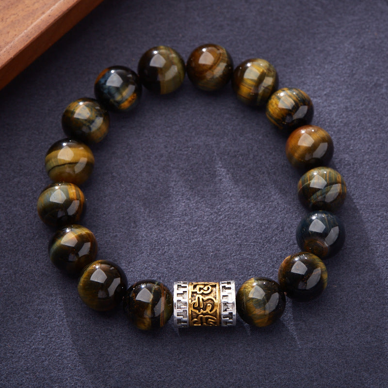 Yellow-blue tiger eye bracelet on a dark fabric surface