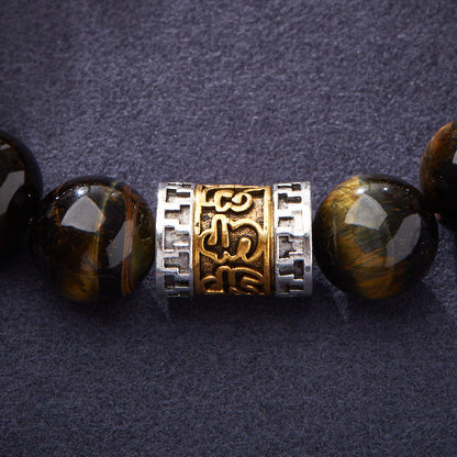 Close-up of the gold-tone script and silver-tone geometric barrel borders