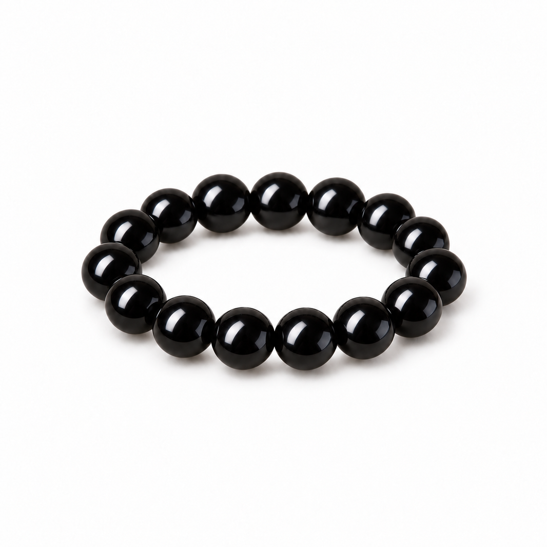 Glossy jet-black obsidian round bead bracelet on white
