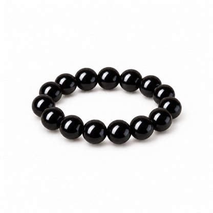 Glossy jet-black obsidian round bead bracelet on white