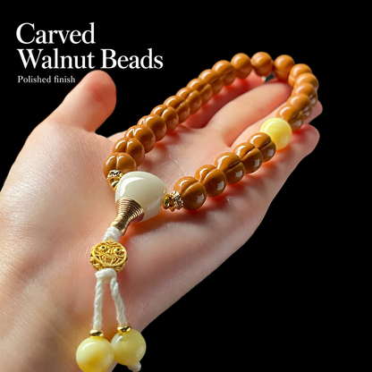 Walnut hand strand with cream charm and yellow accents
