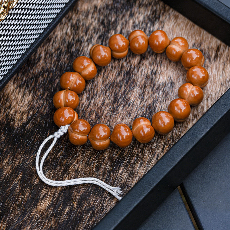 Polished walnut hand strand with white cord