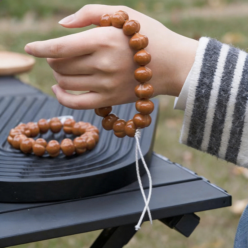 Walnut hand strand held outdoors