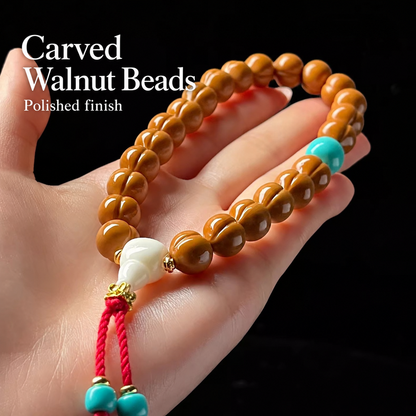 Walnut hand strand with white charm and blue accents, detail