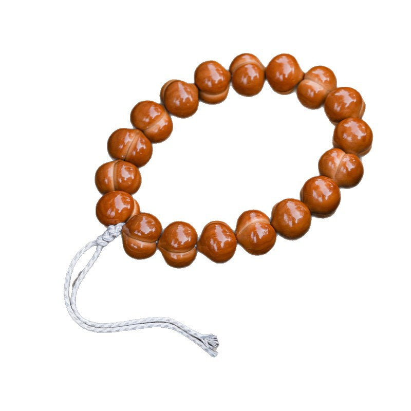 Polished walnut hand strand with white cord on white